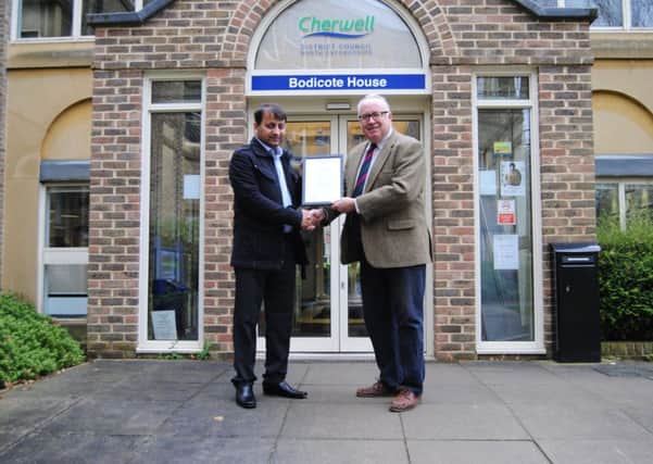 Cllr Kieron Mallon presented taxi driver Satbir Arora with an award after saving a girl from an armed paedophile she met online. Photo: Cherwell District Council NNL-171127-131604001